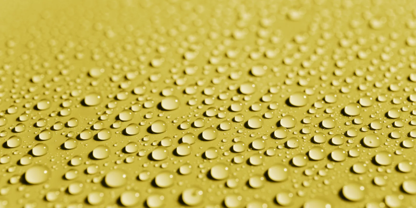 gouttes d'eau sur un matériau de surface jaune ; water droplets on a yellow surface material ; Wassertropfen auf einem gelben Oberflächenmaterial